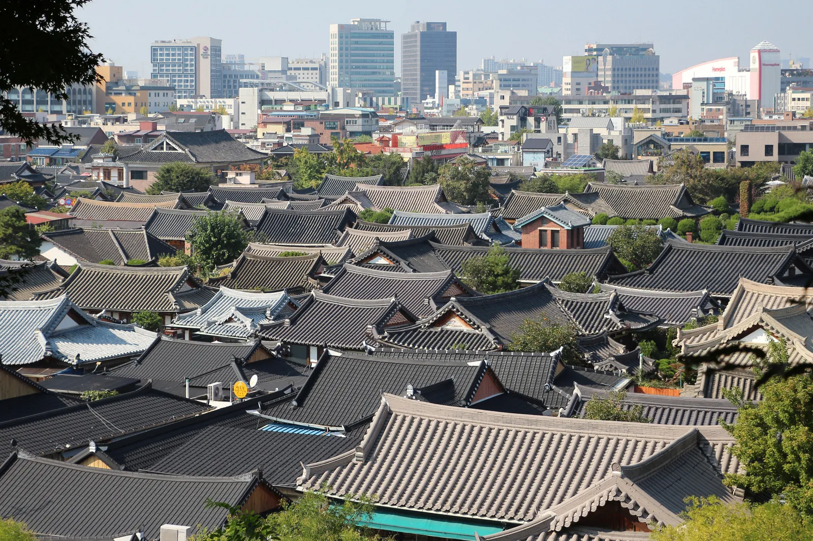 Tiled hanok rooftops of Jeonju Hanok Village with the city behind